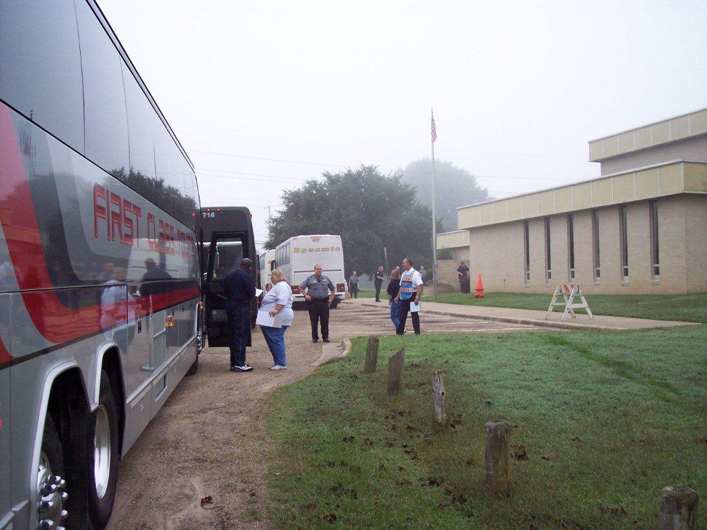 The buses to the shelter arrive, and are greeted by emergency personnel.